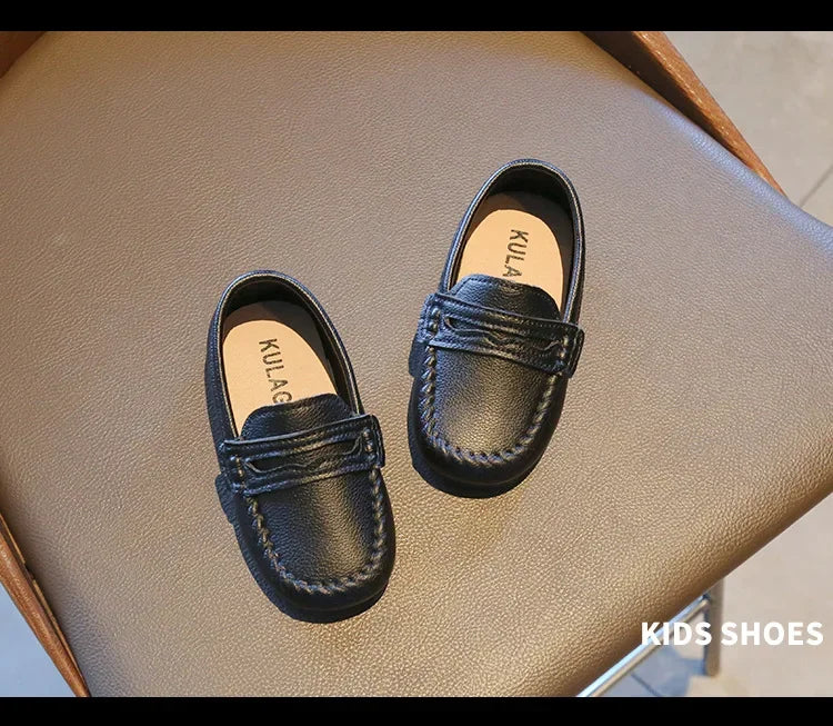 Stylish black leather slip-on loafers for boys, a practical choice for school and formal occasions.