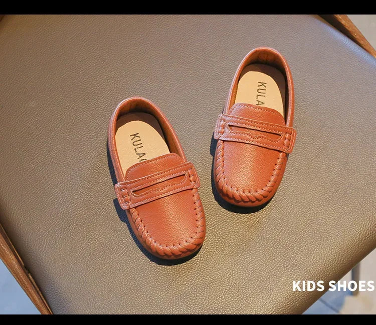 Robust black leather slip-on boys' loafers, built to last through school activities.