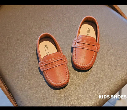 Robust black leather slip-on boys' loafers, built to last through school activities.
