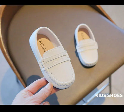 Boys' black leather slip-on durable school shoes, designed for everyday wear and formal events.