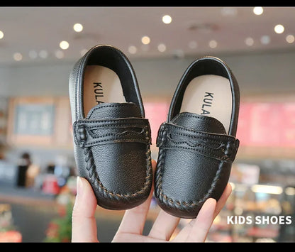 Smart black leather slip-on loafers for boys, a versatile shoe for school and formal occasions.