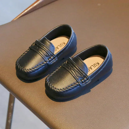 Sleek boys' black leather slip-on school loafers, comfortable kids footwear for daily wear.