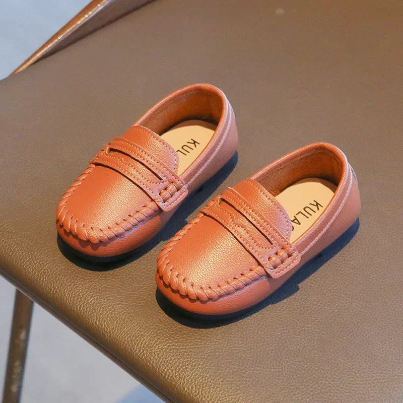 High-quality black leather loafers for boys, a classic slip-on design for formal occasions.