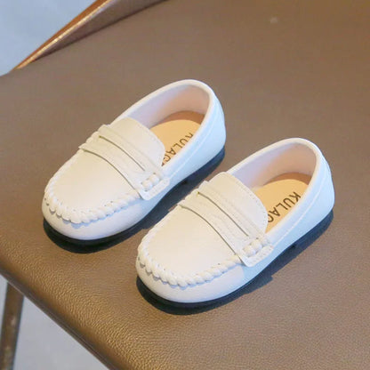 Stylish boys' black leather slip-on shoes, perfect as school uniform footwear or formal events.