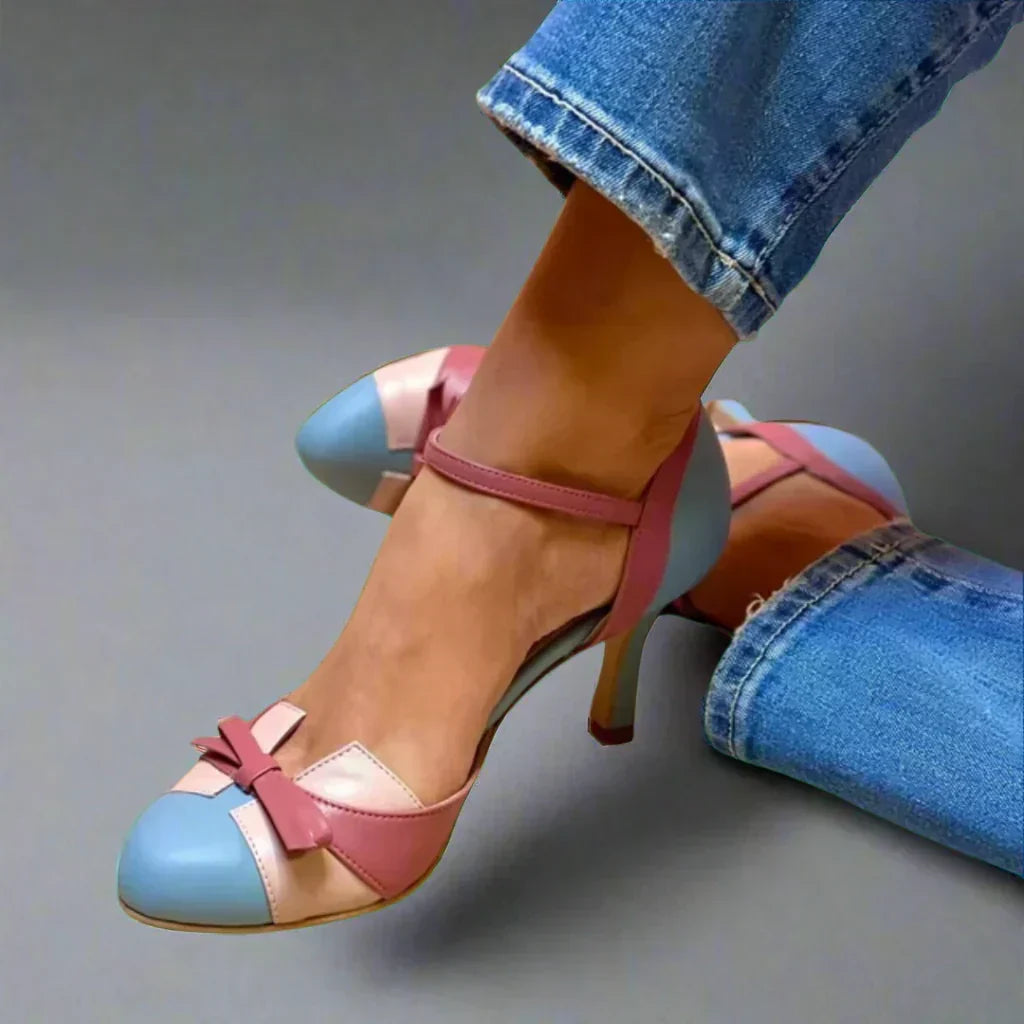 Classic women's mid-heel pumps with elegant bow strap, perfect for formal occasions & dressy events.