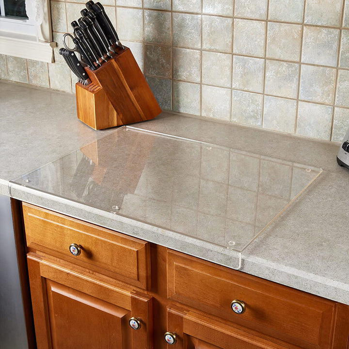 Preparing food safely on a clear, non-slip acrylic cutting board, perfect for fruits, vegetables, and meats.