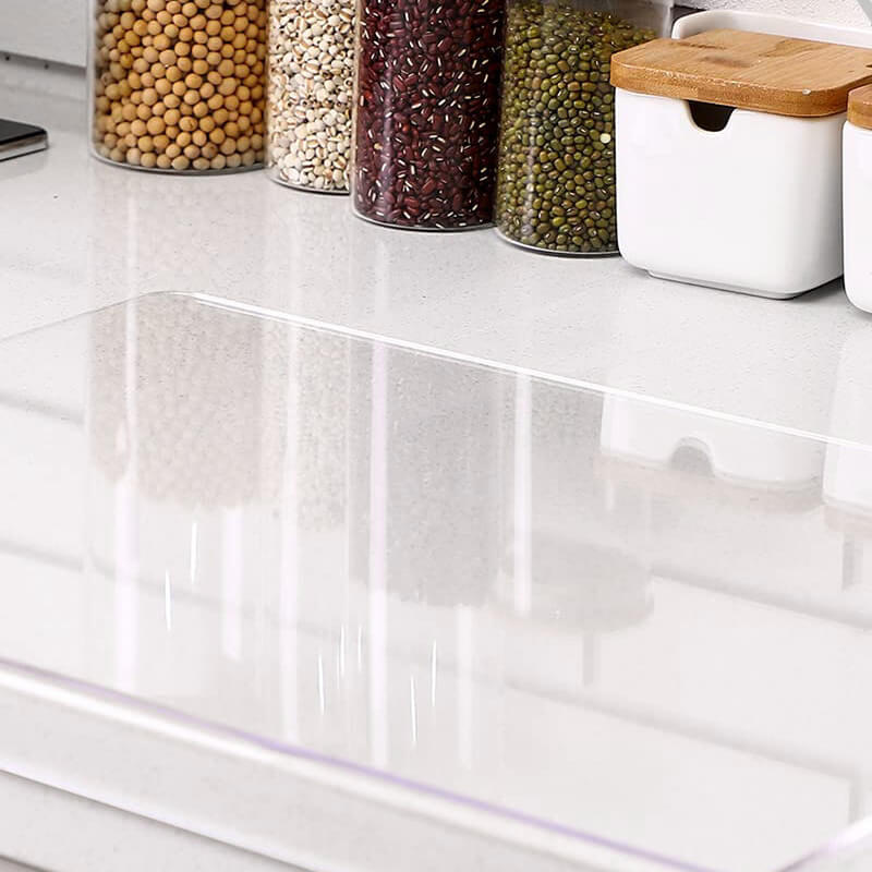Clear non-slip acrylic cutting board for hygienic kitchen food preparation, modern and durable design.