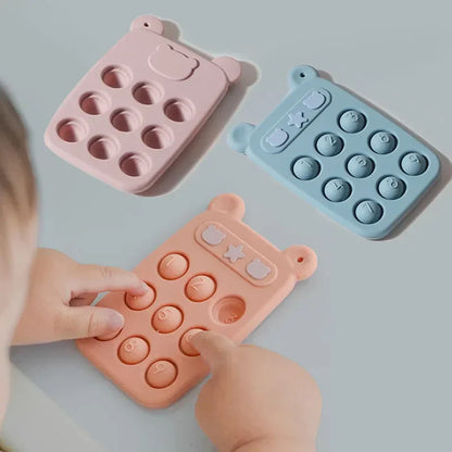Close-up of a blue baby silicone fidget phone teether, ideal for infant sensory play and development.