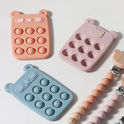 Montage of colorful silicone fidget phone teethers (blue, pink, green) for infant development and sensory play.