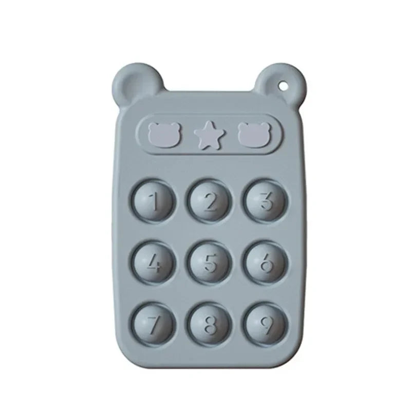 Detailed view of the textured surface on a yellow silicone teether phone, designed for baby's oral exploration.