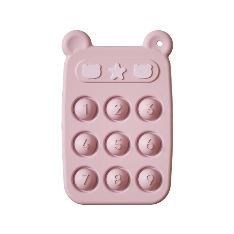 Happy baby chewing on a silicone fidget phone teether, demonstrating its use as a soothing sensory toy.