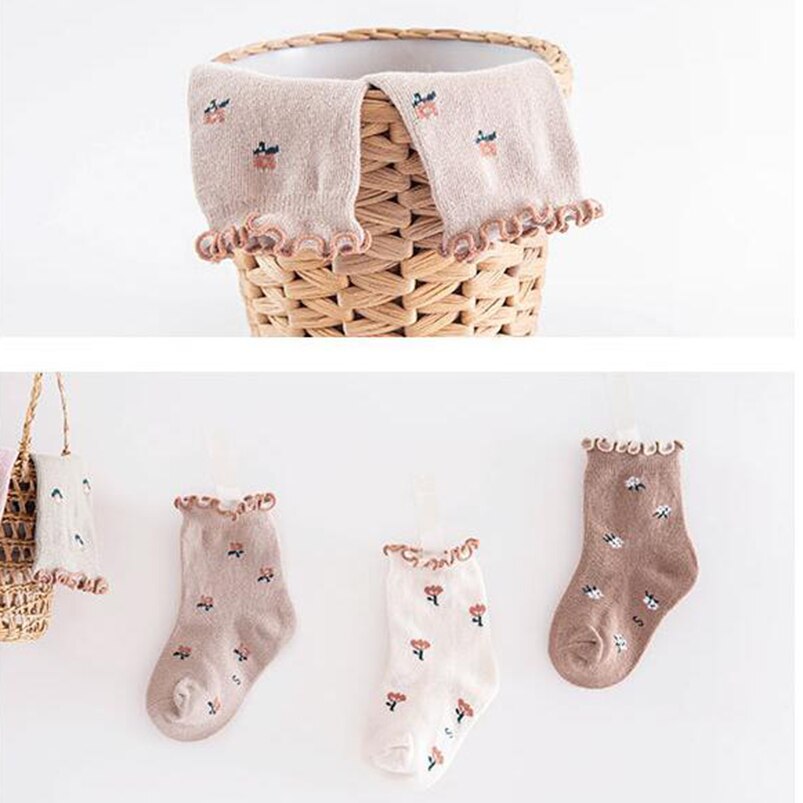 Toddler's feet wearing pink floral ankle socks, highlighting the comfortable cotton material.