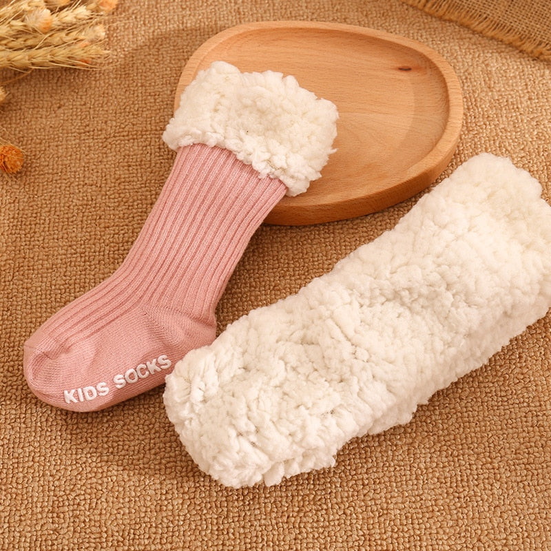 Display of various patterned cotton baby socks, ideal for keeping tiny feet warm in winter