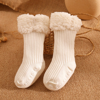 Assortment of warm baby socks, including infant and toddler sizes, made from soft cotton