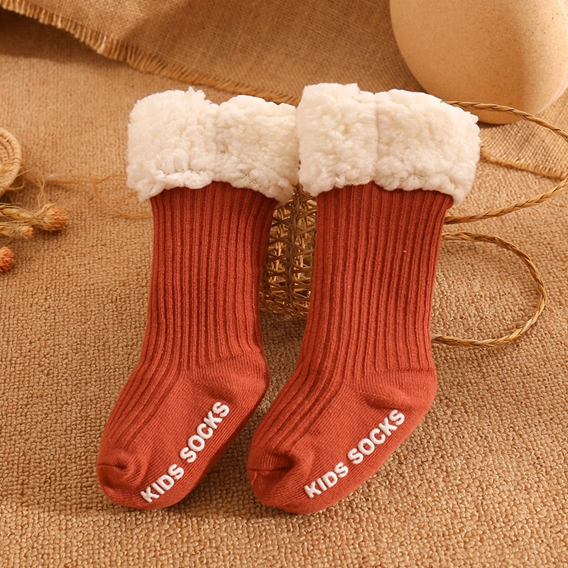 A baby crawling on a rug, showcasing the non-slip features of their cozy winter socks