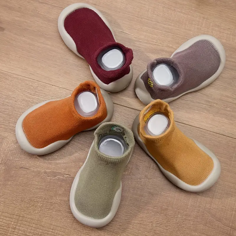 Toddler taking first steps in comfortable, breathable barefoot shoes with a grippy flexible sole