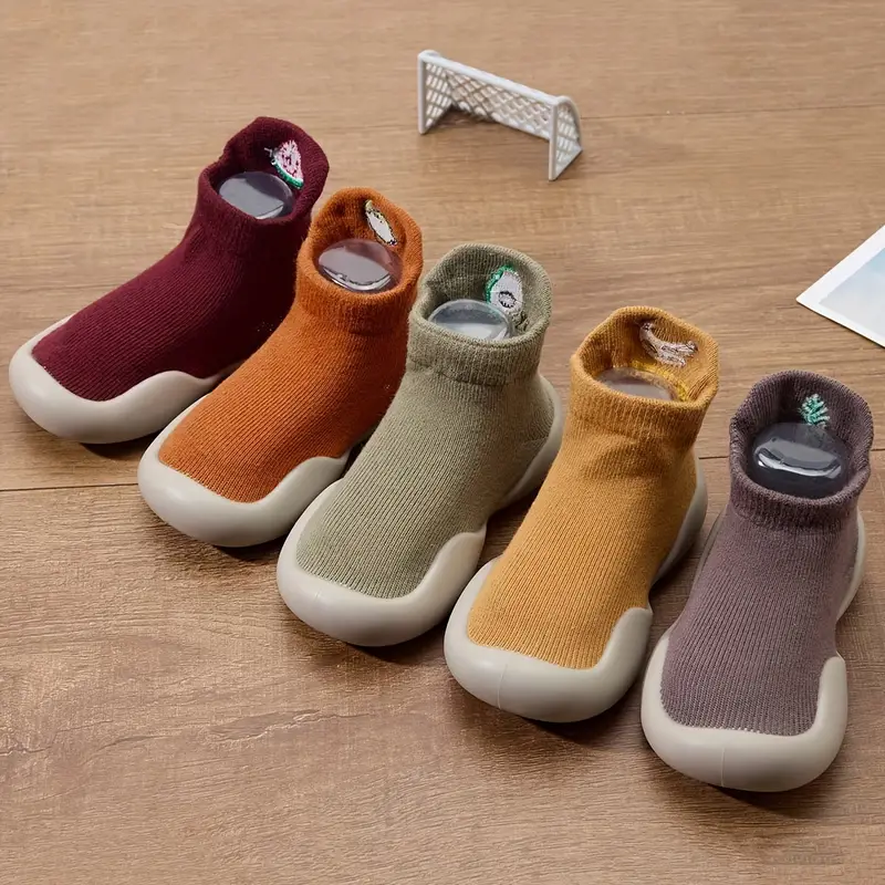 Unisex infant flexible sole shoes in a neutral color, ideal for developing feet and natural movement