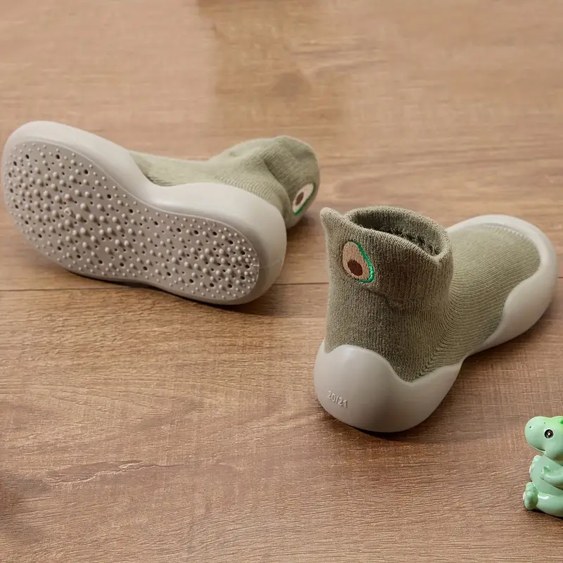 Overhead shot of a child's colorful flexible sole barefoot shoe, highlighting the soft cotton material