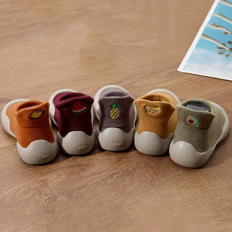 Side view of a baby's flexible sole shoe, showcasing the durable rubber sole and easy-to-wear design
