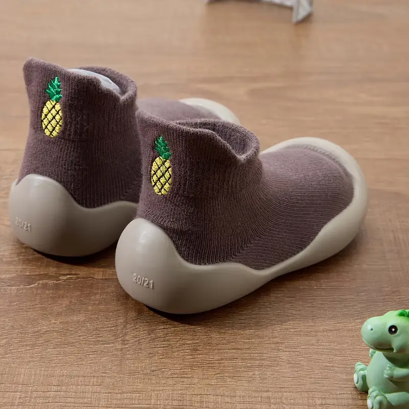 Detail of the flexible rubber sole on a toddler's shoe, designed for natural foot development and grip