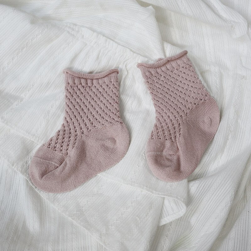 Collection of varied colored breathable cotton mesh infant socks, ideal for toddlers' comfort.