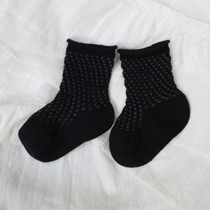 Styled image of a baby's outfit featuring adorable soft cotton mesh ankle socks.
