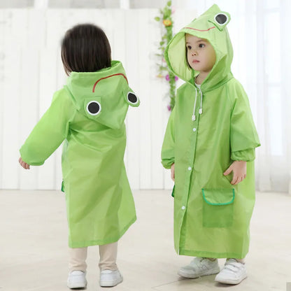 Full shot of a happy toddler wearing a blue frog waterproof kids' raincoat.