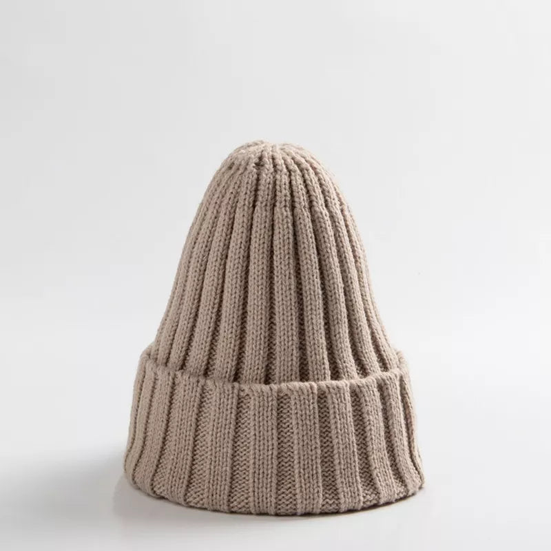 Folded unisex baby crochet winter beanie hat in a deep navy, showcasing the knit.