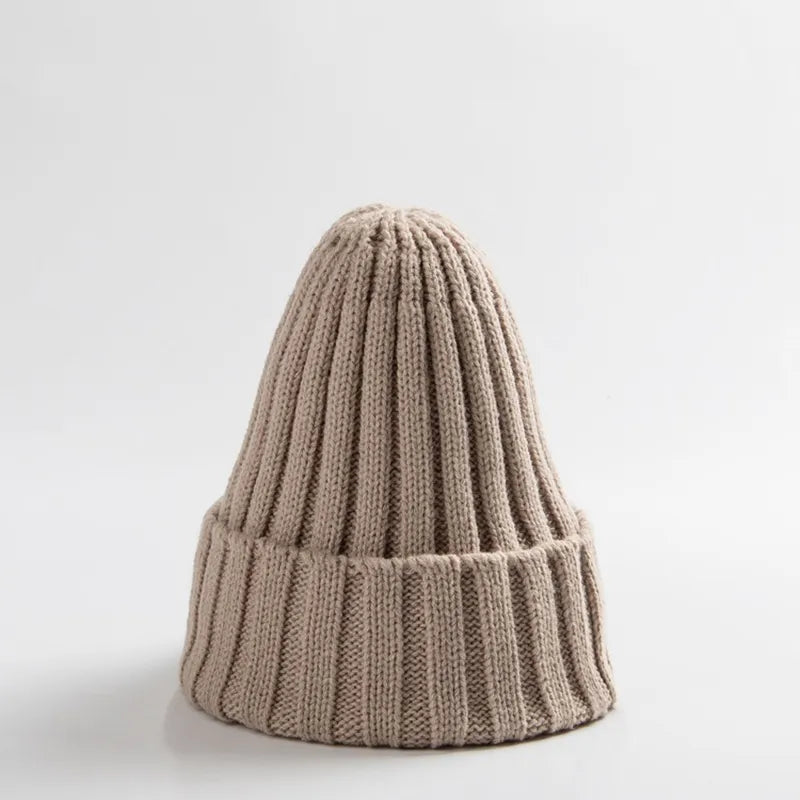 Front view of a simple, elegant unisex baby crochet winter beanie hat in white.