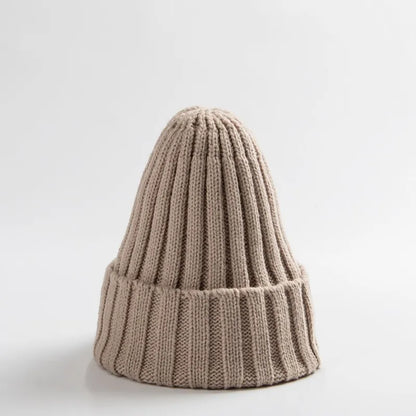 Front view of a simple, elegant unisex baby crochet winter beanie hat in white.
