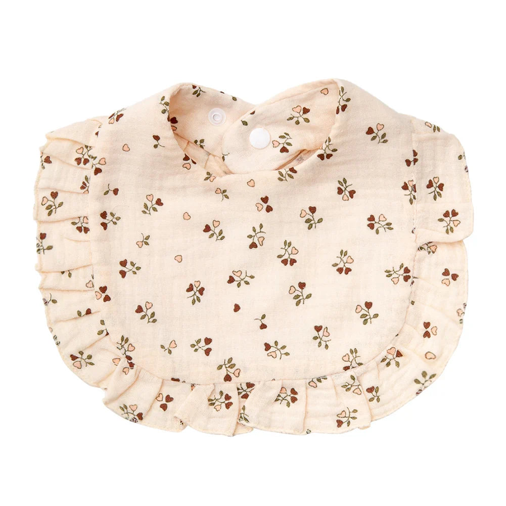 Close-up of the breathable cotton fabric and vivid floral design of a baby bandana bib