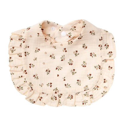 Close-up of the breathable cotton fabric and vivid floral design of a baby bandana bib