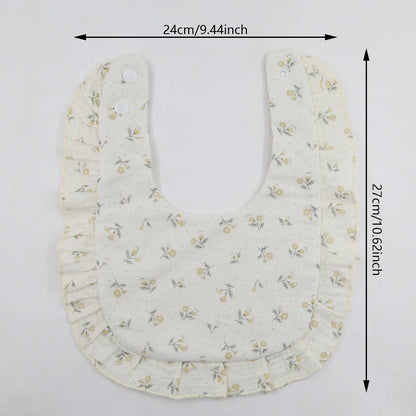 Flat lay of a pastel floral print cotton bandana bib, newborn essential feeding scarf