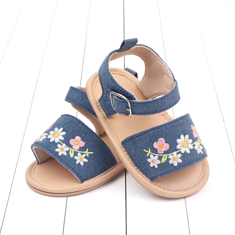 Detail of the floral embroidery on baby girl's summer sandals, highlighting the intricate design