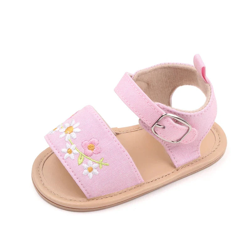 Underneath view of baby girl's embroidered floral sandals, showing the non-slip soft sole design