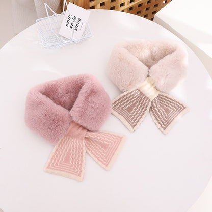 Detail of the secure fastening on a baby girl's faux rabbit fur scarf, ensuring warmth and safety