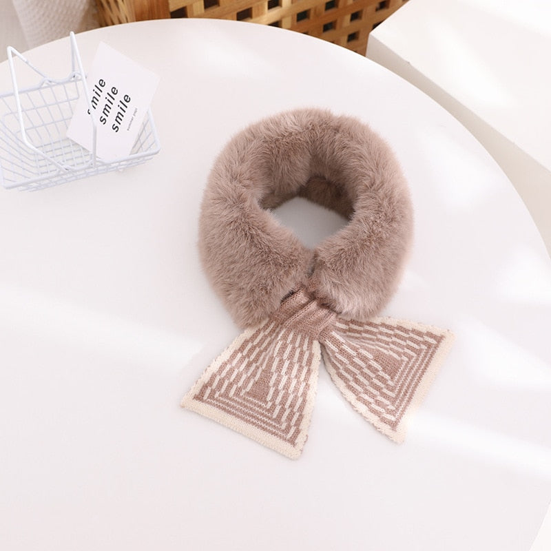 Soft faux rabbit fur scarf in white, draped on a hanger, highlighting its texture for baby girls' winter fashion