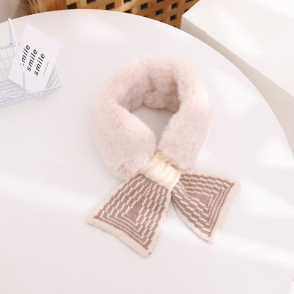 A baby girl smiling, bundled up in a warm, plush faux fur scarf, a must-have for winter warmth