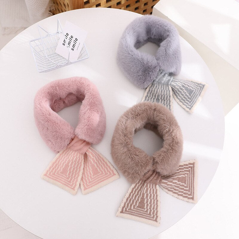 Infant wearing a super soft, hypoallergenic faux rabbit fur scarf in pink for ultimate winter warmth