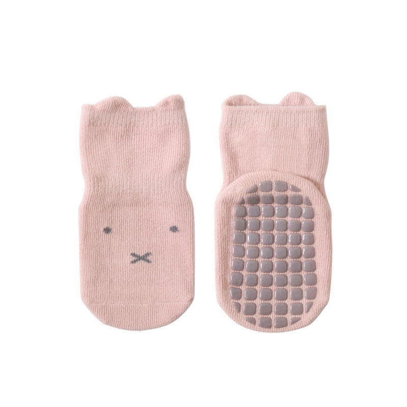 Toddler wearing soft non-slip combed cotton baby socks, providing warmth and grip for little feet