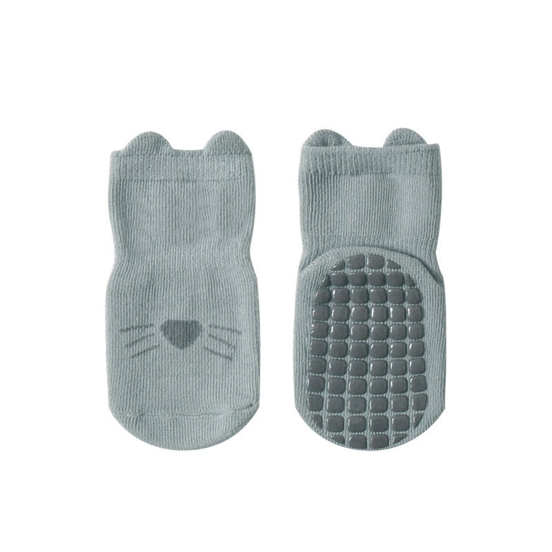 Bottom view of non-slip grips on combed cotton baby socks, ideal for safe play on smooth floors