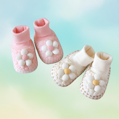 Close-up of cozy plush floral baby booties for infants, soft sole winter wear.