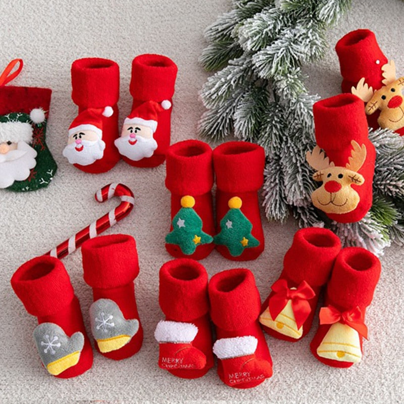 Close-up of festive red baby Christmas socks with anti-slip soles, perfect for newborns and toddlers.