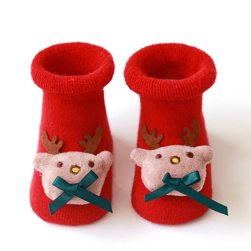 Festive anti-slip baby socks in a bright red hue, adorned with playful Christmas motifs.