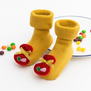 Packaging shot of anti-slip baby Christmas socks, emphasizing their cozy and safe qualities.