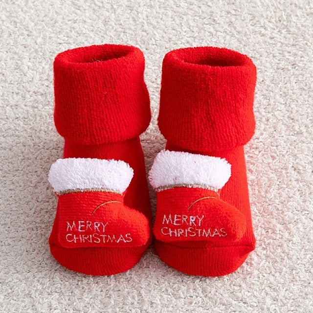 Pair of cozy newborn Christmas socks with grippy bottoms, ideal for festive and safe play.