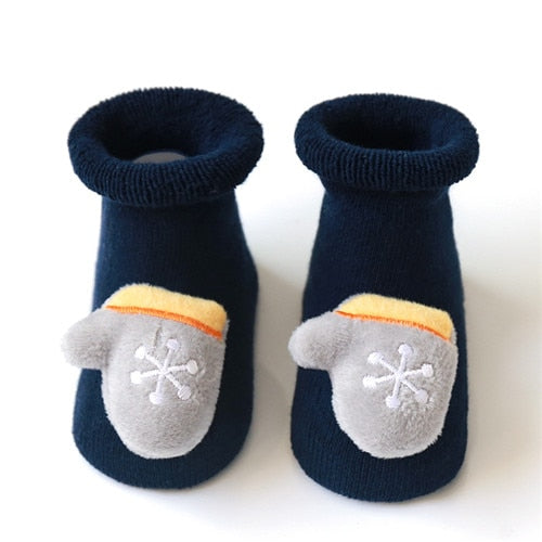 Studio shot of anti-slip Christmas infant socks, highlighting their soft texture and holiday appeal.
