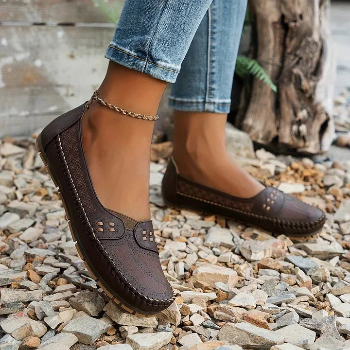 Front view of comfortable women's loafers, emphasizing roomy toe box & perforated design.