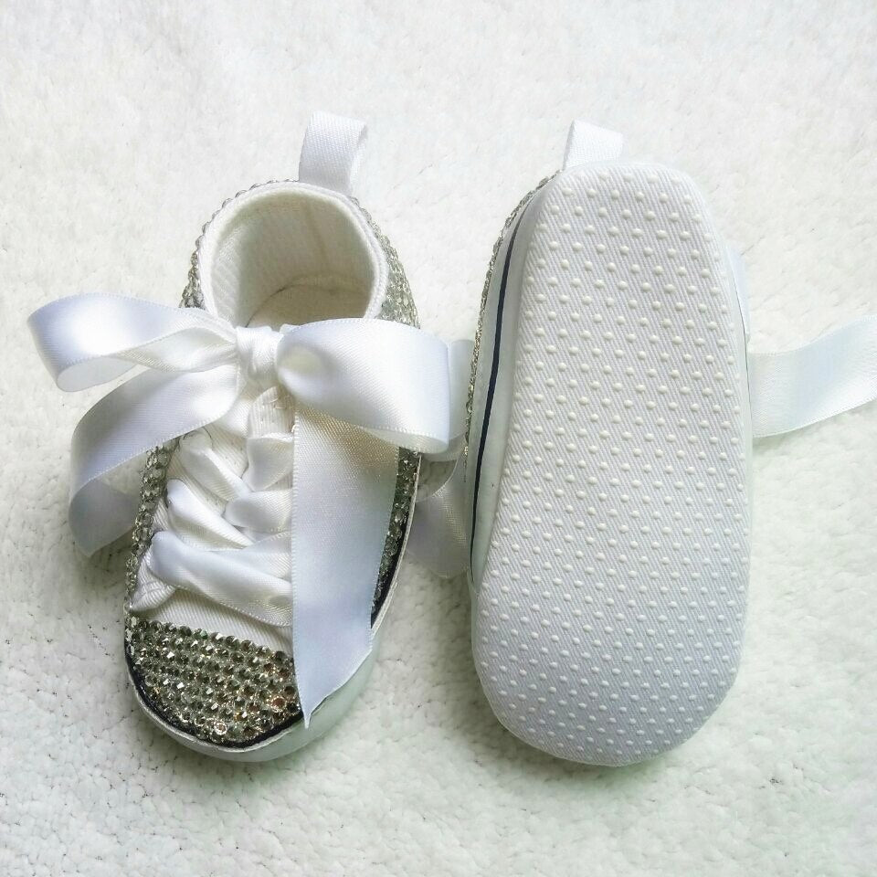 Adorable baby girl's glitter Mary Jane shoes with a charming bow, perfect for special occasions & toddler outfits.