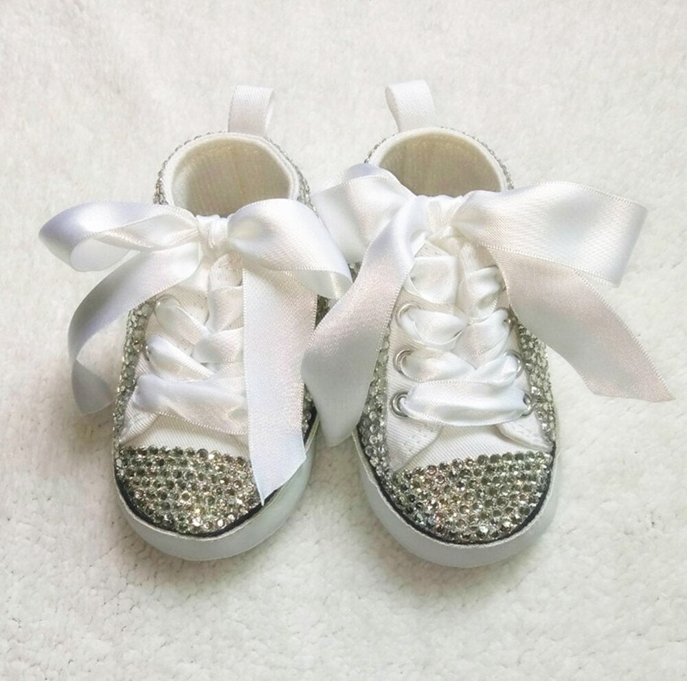 Pair of handmade glitter Mary Jane infant shoes in a vibrant pink, embellished with a sweet decorative bow.